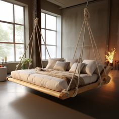 a swing bed with pillows hanging from it's sides