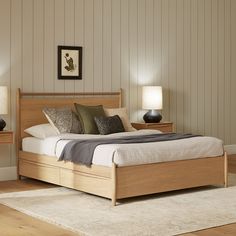 a bedroom with a bed, nightstands and two lamps on either side of the bed