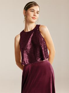 a woman wearing a purple dress with sequins on it