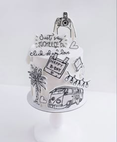 a white cake decorated with black and white doodles on it's side