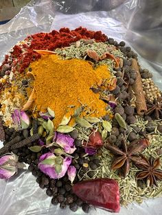 an assortment of spices and herbs arranged in a circle on top of plastic wrapper