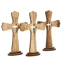 three wooden crosses are shown on a white background