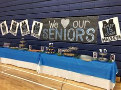 a table with food and decorations on it in a gym area that says we love our seniors