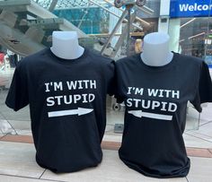 "I'm With Stupid Shirt / Matching Couple Shirts / Funny Sarcastic T Shirt / Short Sleeve Sarcasm Tee Gift / Couple Apparel  This cute and comical \"I'm With Stupid\" t-shirt set is the perfect choice for couples who want to showcase their playful dynamic in style. Featuring a classic unisex t-shirt design, both of the shirts reads \"I'm With Stupid\"  Crafted from comfortable and breathable cotton, these shirts are ideal for any activity, from running errands to a night out on the town. The shirts come in a variety of sizes, making it easy to find the perfect fit, and the stylish black color ensures that the shirts will always be in style.  Whether you're shopping for a fun couples gift for a special occasion, or you're simply looking for a way to add a little humor to your wardrobe, this Best Friend Shirts Funny Boys, Matching Couple Shirts Funny, Funny Couples Shirts, Matching T Shirts Couple, Matching Outfits Couples, Couples Shirts Funny, Couple Shirts Relationships, Matching Shirts Couple, Couple Shirts Funny