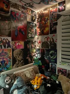 a room filled with lots of posters and stuffed animals on the wall next to it