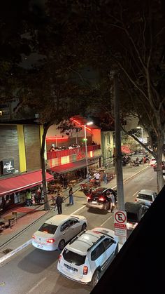 cars are parked on the street at night