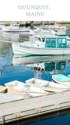 there are many small boats docked in the water near each other and one is white