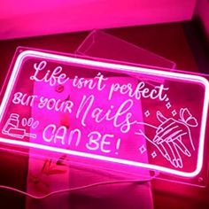 a neon sign that says life isn't perfect but your nails can be