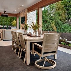 an outdoor dining area with table and chairs