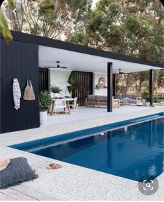 an outdoor pool area with a patio, dining table and couches next to it