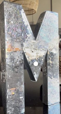 the letter m is made out of small mosaic tiles