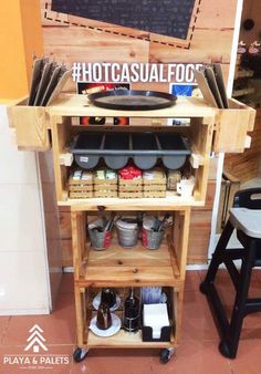 a wooden cart filled with lots of food and drinks on top of a tiled floor