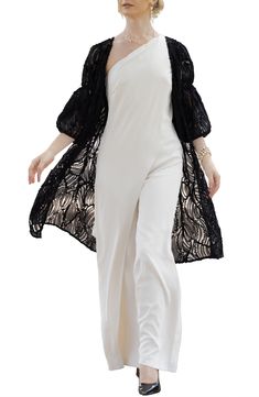 Swirling soutache ribbons pattern a ready-to-layer ruana fashioned in a lightweight, open-front silhouette framed by billowy balloon sleeves. Open front Three-quarter sleeves 100% polyester Hand wash, line dry Imported Black Spring Evening Shrug, Black Evening Shrug For Spring, Black Shrug For Evening In Spring, Elegant Spring Wrap Shrug, Elegant Black Shrug For Spring, Elegant Open Front Shrug For Spring, Elegant Long Sleeve Beach Outerwear, Elegant Beach Outerwear With Open Front, Elegant Open Front Beach Outerwear