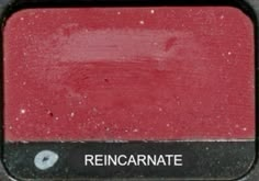 a close up of a red and black square with the word rencarnate on it