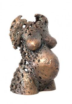 a bronze sculpture of a woman's breast and head is shown against a white background