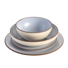 three plates and two bowls are stacked on top of each other