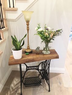 an old sewing machine with flowers on it and a lamp in the corner next to it