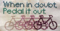 a cross stitch pattern with two bicycles and the words when in doubt, pedal it out