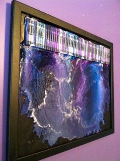 a painting hanging on the wall with purple and blue colors in it's frame