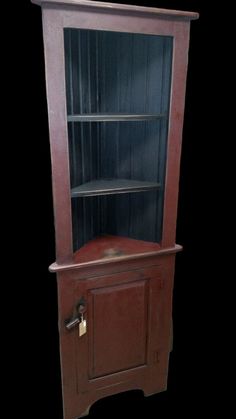 an old wooden bookcase with glass doors on the front and bottom shelves, in dark wood