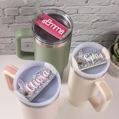 three coffee mugs sitting next to each other on a table