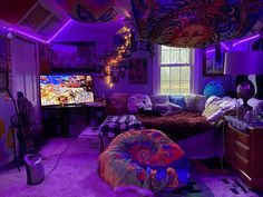 a living room filled with furniture and purple lighting on the ceiling is lit up by colorful lights