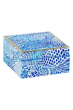 a blue and white box sitting on top of a white surface with an animal print pattern