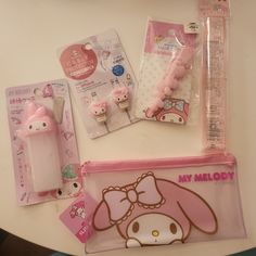 some hello kitty items are laying out on a table