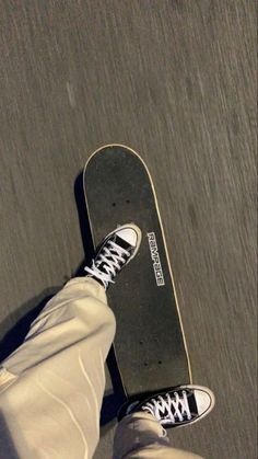 a person standing with their feet on a skateboard