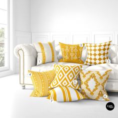 a white couch with yellow and white pillows