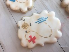 decorated cookies with different designs on them sitting on a wooden table next to other cookies