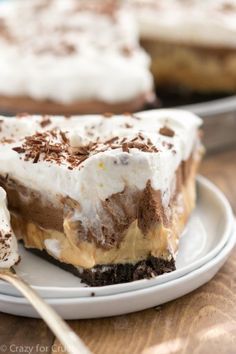 a piece of pie on a white plate with a fork in front of the slice