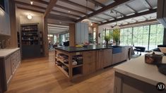 an open kitchen and dining room with wood flooring