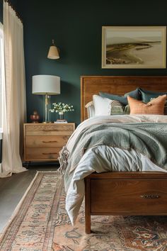 a bedroom with green walls and wooden furniture