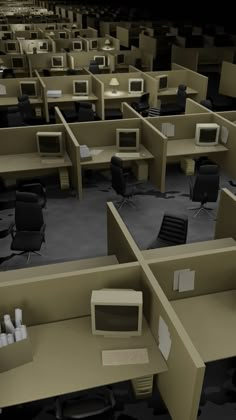 an office cubicle with computer screens and desks in the middle, all empty