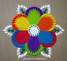 a colorful paper fan sitting on top of a wooden table