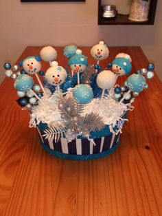 a blue and white cupcake decorated with snowmen