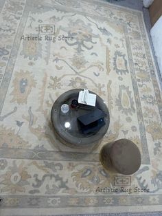 a coffee table on the floor with a book and some other items sitting on it