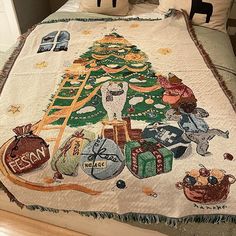 a bed with a christmas tree quilt on it