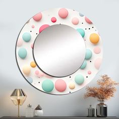 a round mirror sitting on top of a dresser