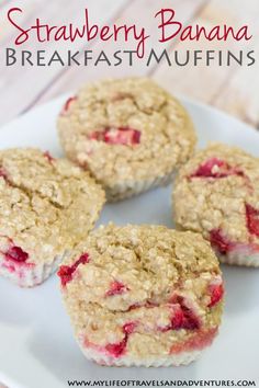 four muffins on a white plate with strawberries in the middle and oatmeal crumbs