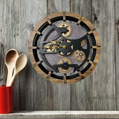 a clock made out of wood with gears and spoons next to it on a shelf