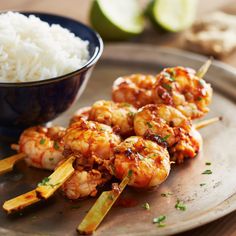 some shrimp skewers and rice on a plate