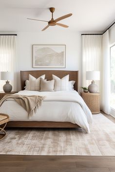 a bedroom with a large bed and ceiling fan