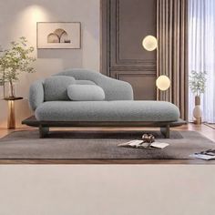 a living room with a couch, table and lamp on the wall next to it