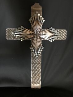 a metal cross on a black background