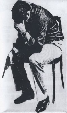 a black and white drawing of a man sitting on a chair with his head down