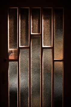 an open door with glass panels on it's side and light coming through the window