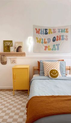 a bedroom with a bed, nightstands and a sign on the wall that says long live boyhood