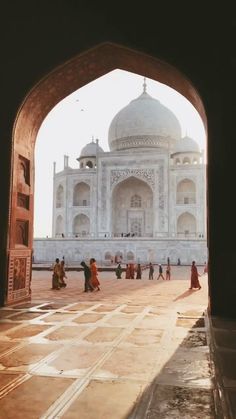 people are walking around in front of the taj - e - azr mosque